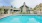a swimming pool in front of a house