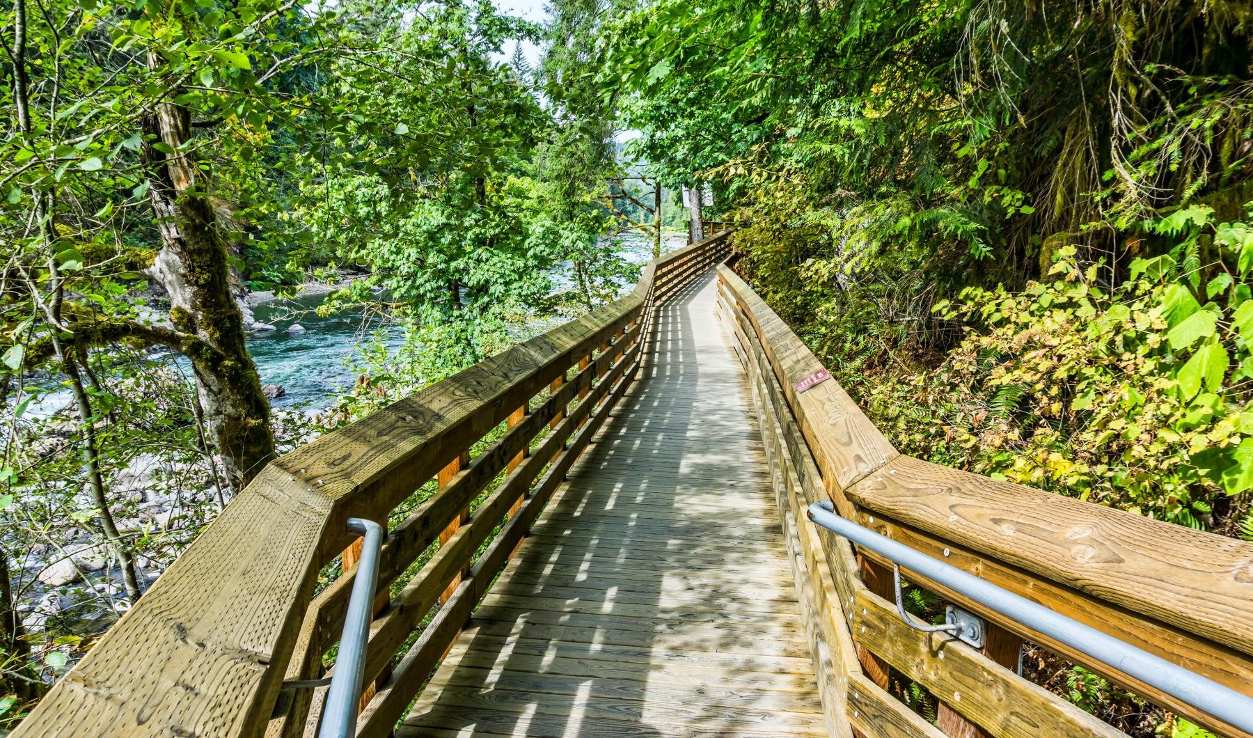 A beautiful community at the heart of all your passions a wooden bridge over a river
