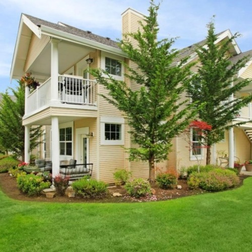 Find your perfect fit at Echo Ridge Apartments a large house with a lawn and trees in front of it