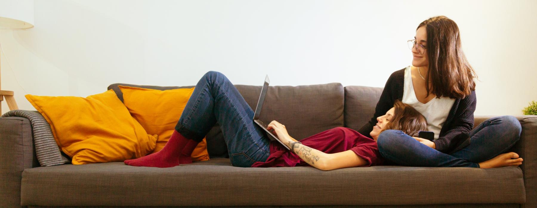 a person and a child sitting on a couch